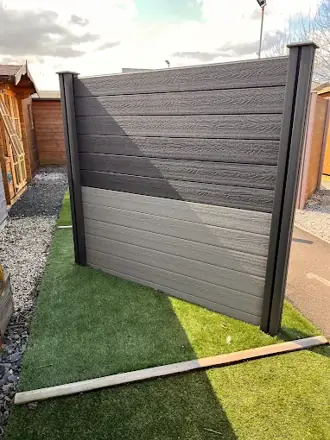Grey composite fence panels with matching posts on an artificial-grass garden